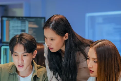 Students working together at their screens