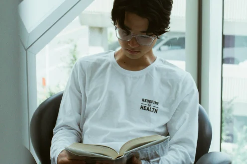 Student reading by a window