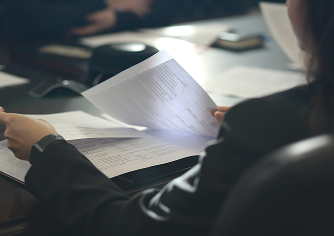 Hands reviewing patent documents